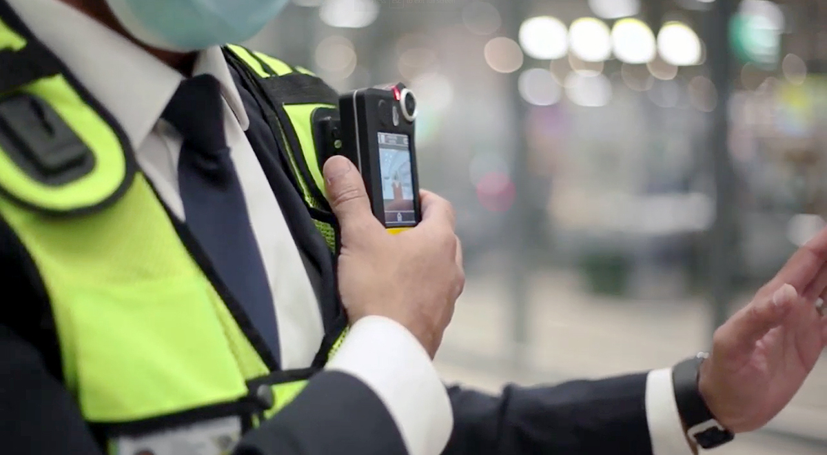 Security guard waering a body worn camera in a supermarket retail environment